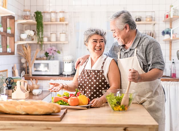 A couple cooking in the kitchen.